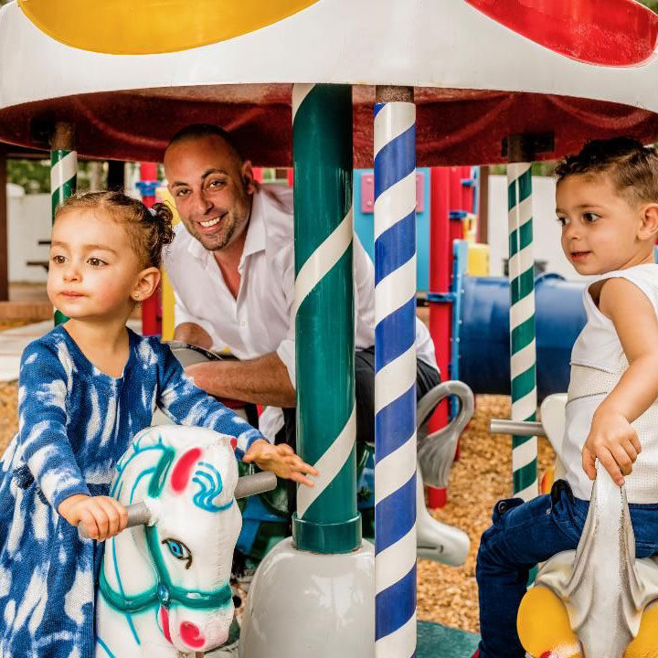 Author Zack Bush on a carousel with his children